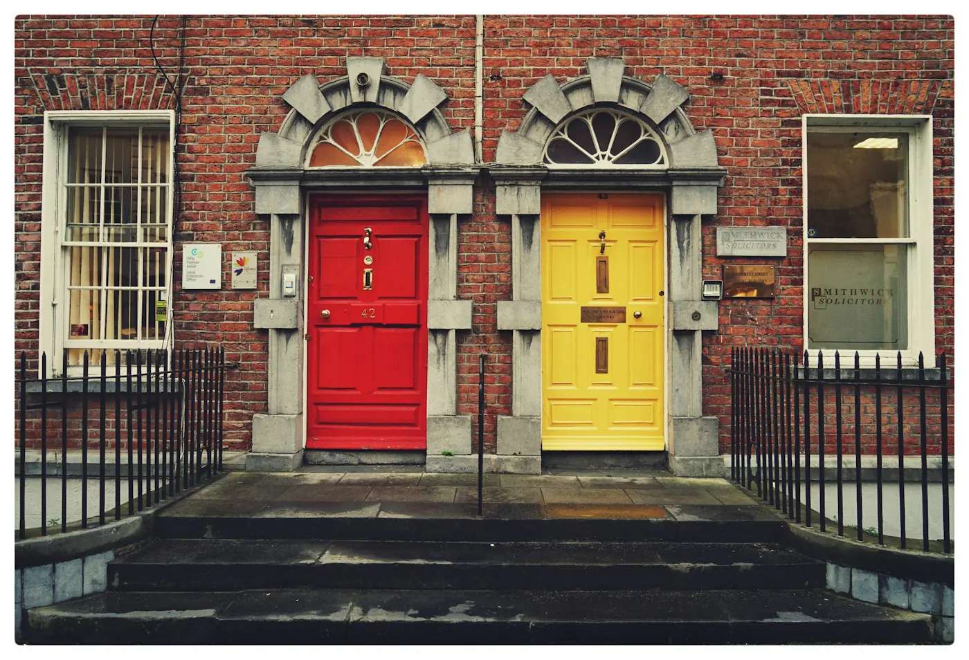 Red and yellow Georgian doors side by side