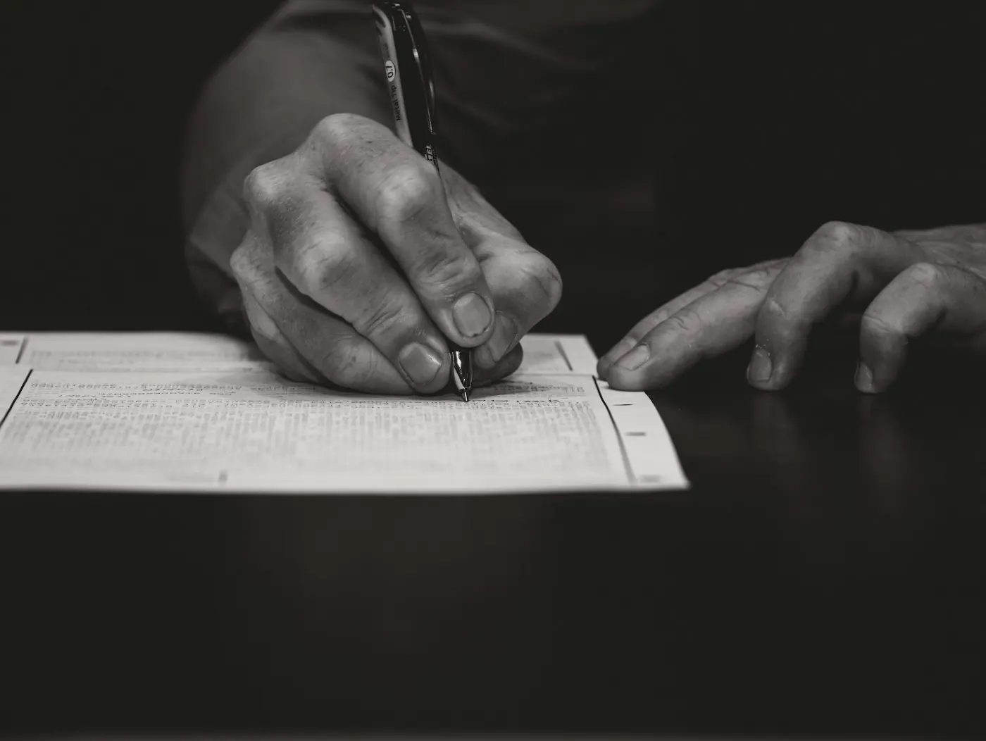 Hand signing a document with a fountain pen