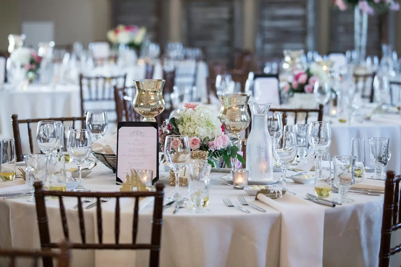 Long tables set with linen, glassware and flowers