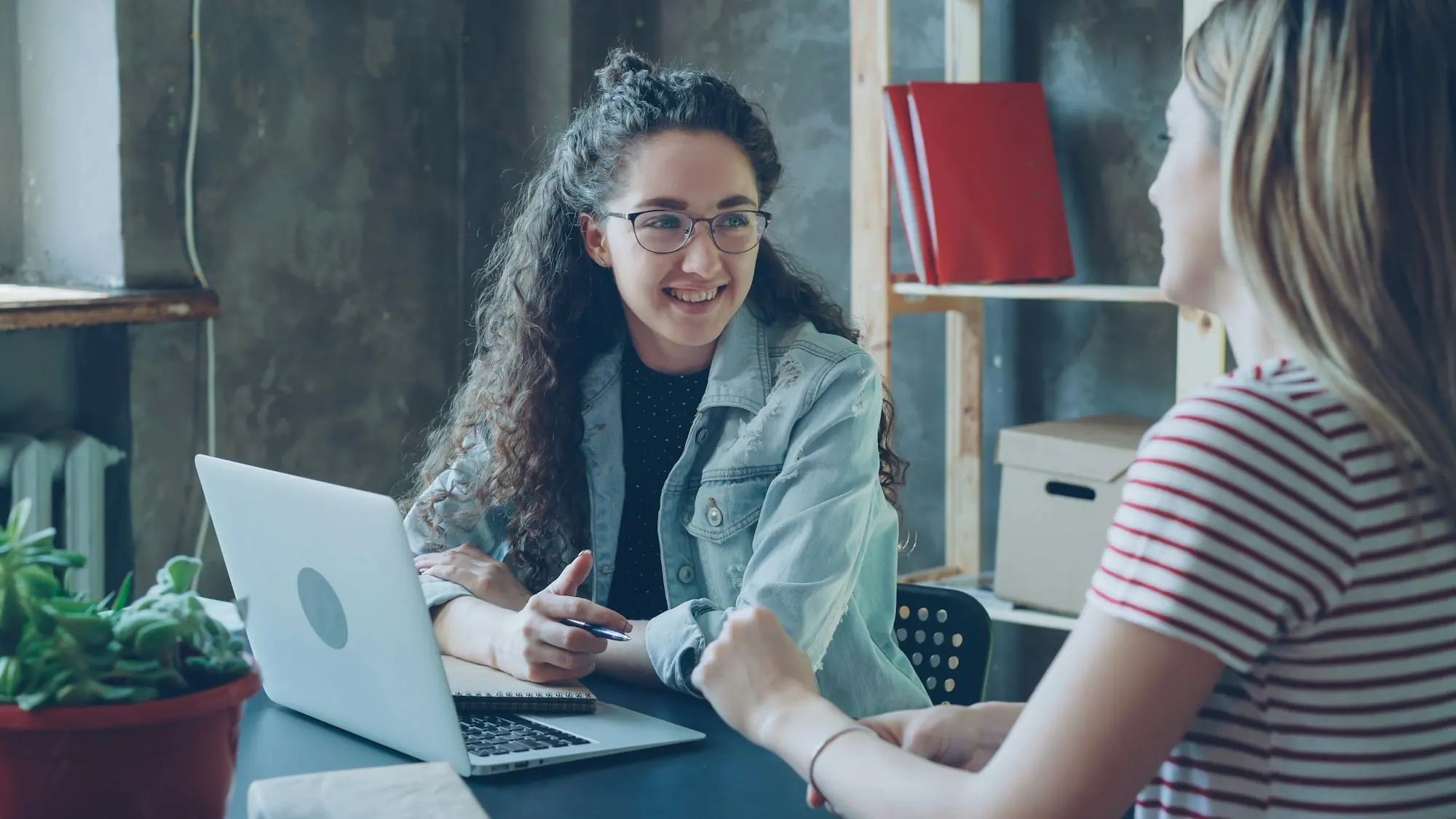 Accountant smiling while meeting a client across a desk