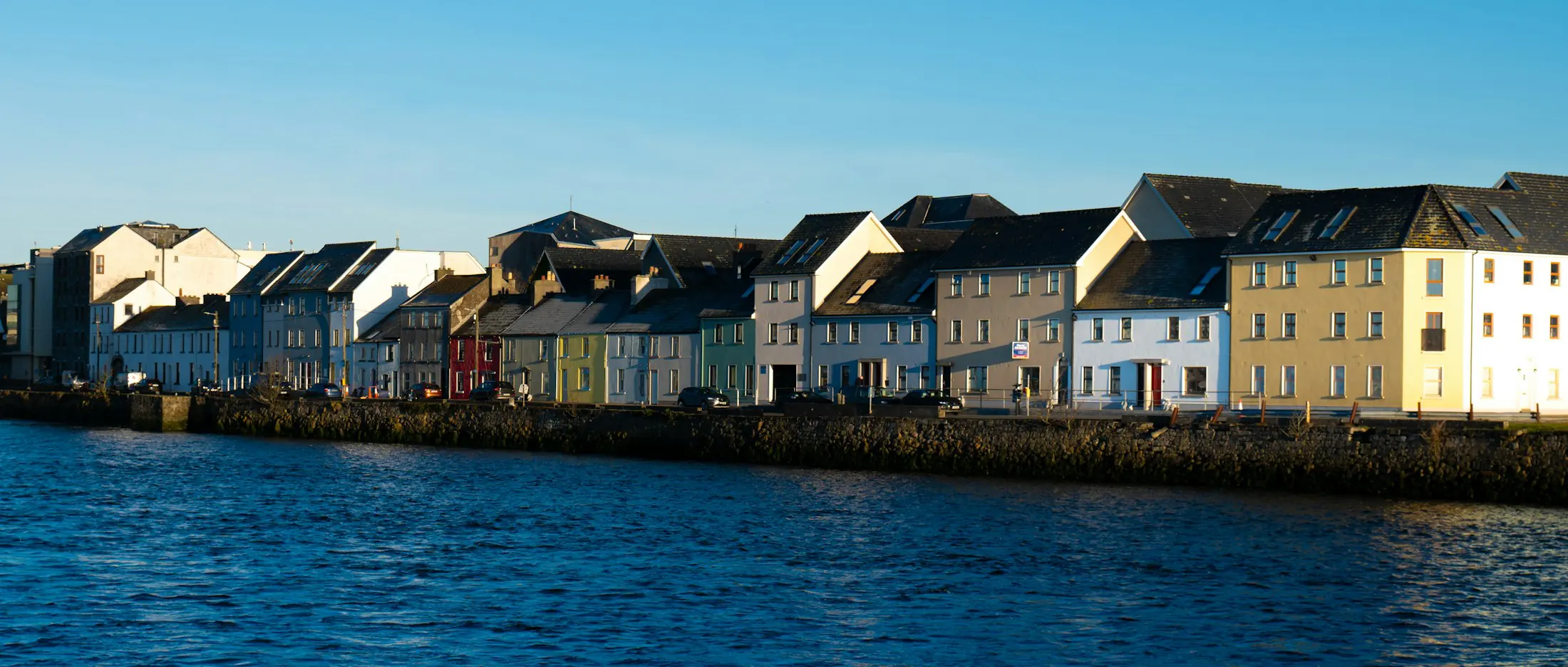 Colourful houses along the water in Galway