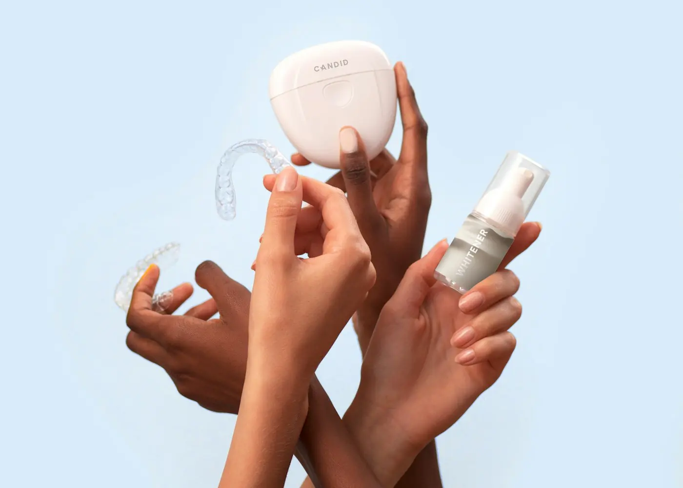 Hands holding clear aligners and a case