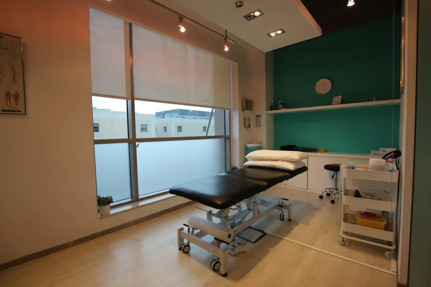Bright treatment room with a physiotherapy table