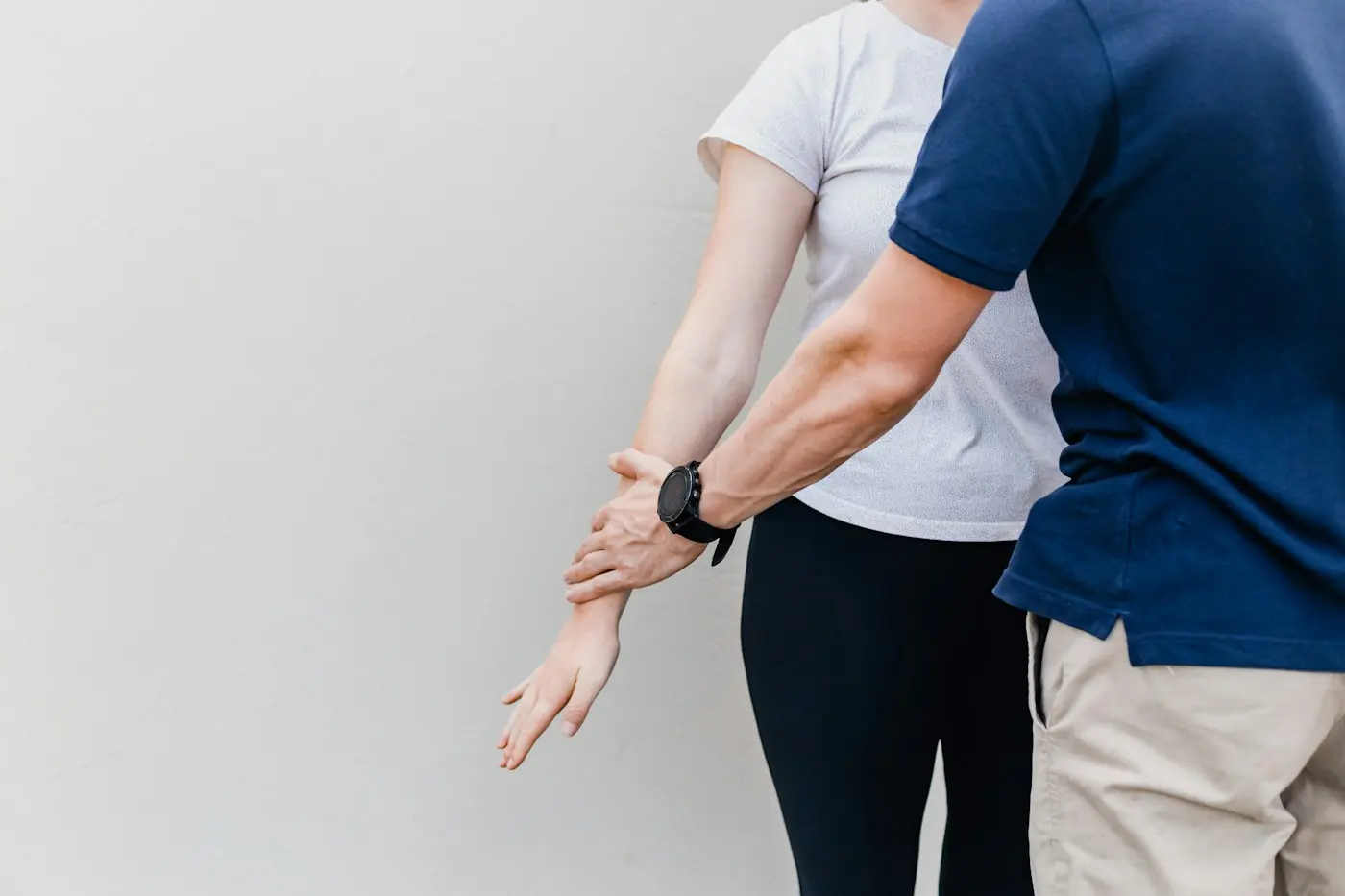 Physiotherapist assessing a patient's shoulder and arm movement
